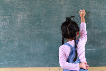 Kid write on chalkboard