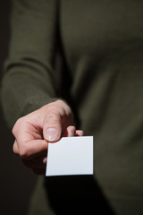 Businesswoman's hand reaching out a business card