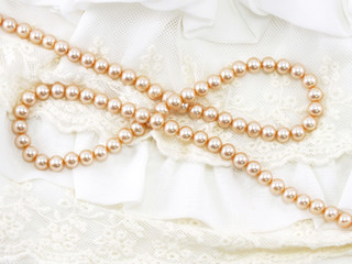 beautiful creamy pearl necklace on a lace background
