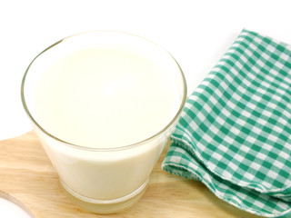 cup of milk on white wooden table view from above with copy space