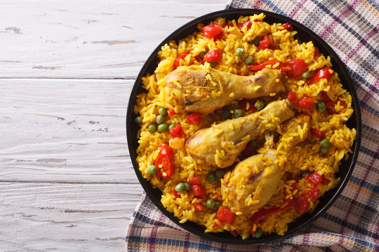Spanish paella with chicken and vegetables. horizontal top view
