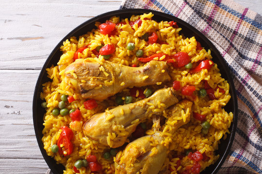paella with chicken and vegetables closeup. horizontal top view
