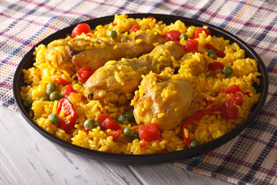 Spanish paella with chicken closeup on a plate. horizontal