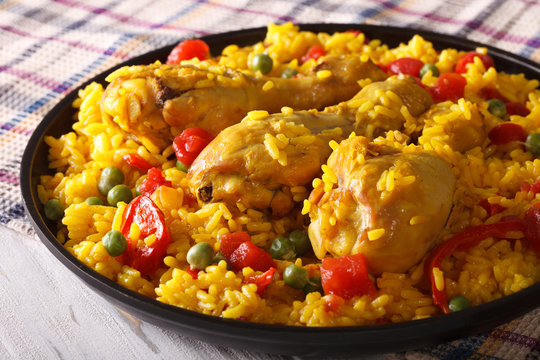 Paella with chicken meat and vegetables closeup. horizontal
