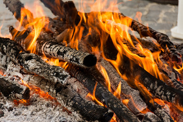 Burning wood in the fireplace, preparation of charcoal