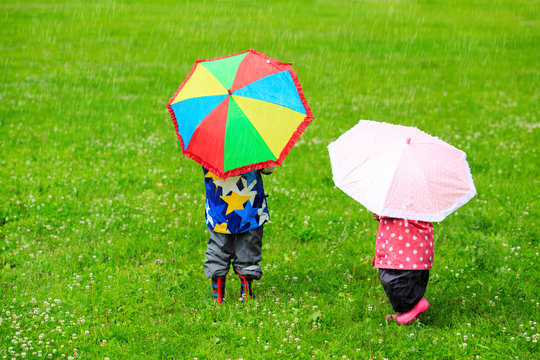 kids with colorful umbrellas on rainy day