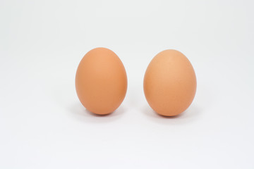 Two eggs placed vertically on a white background.