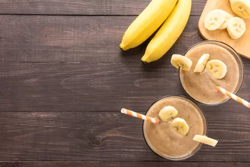 Stickers pour porte Milk-shake Top shot banana smoothie on wooden background