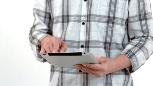 Mid section of a man using his tablet