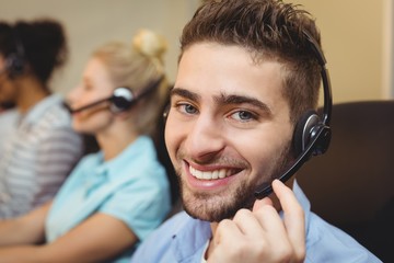 Portrait of smiling executive in call center