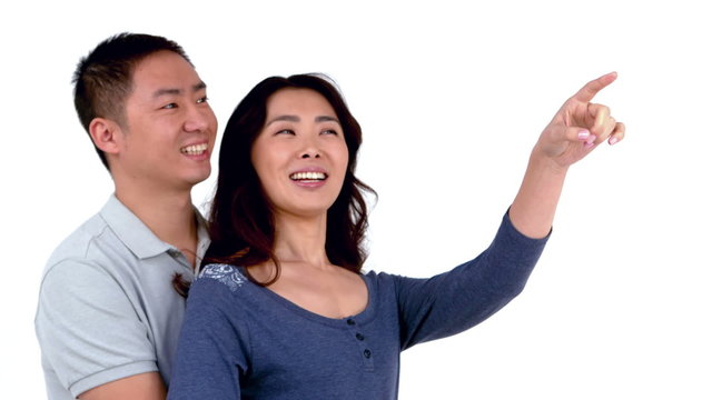 Smiling Asian woman pointing over the screen