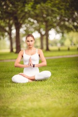 Full length portrait of woman sitting in lotus pose 