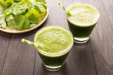 Healthy green smoothie on rustic wood background