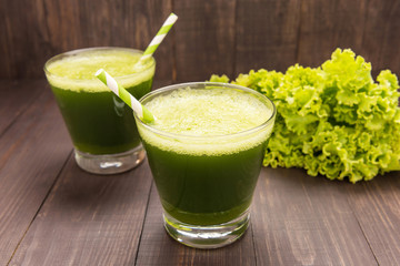 Healthy green smoothie with lettuce on rustic wood background