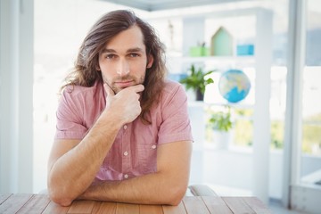 Portrait of confident man with hand on chin