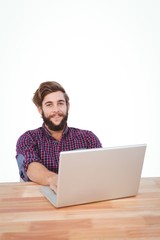 Portrait of happy hipster working on laptop