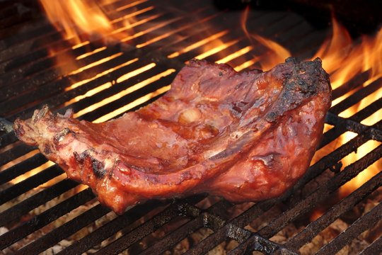 Baby Back Or Pork Spareribs On The Hot Flaming Grill