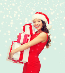 woman in santa helper hat with many gift boxes