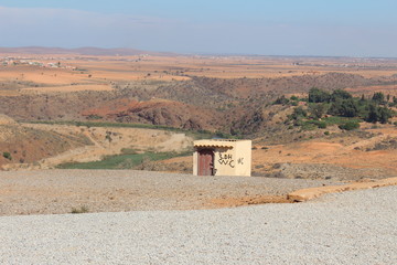 Small public convenience building in the desert.
