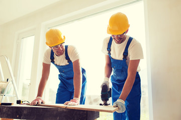 group of builders with tools indoors