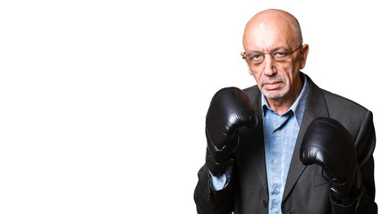 Naklejka premium Senior man in a suit and boxing gloves isolated on white backgro