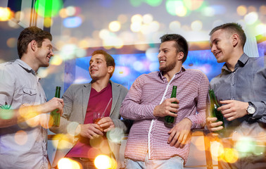 group of male friends with beer in nightclub