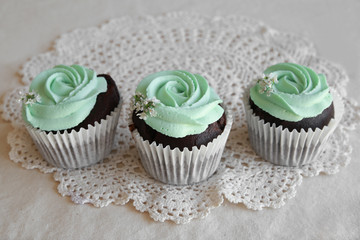 Homemade chocolate cupcake with turquoise rose frosting