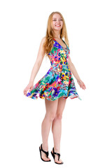 Full length of young cute smile girl stands on tiptoe in summer dress posing isolated on white background, positive human emotion, facial expression