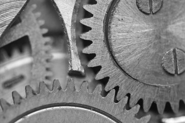 Black-and-white Metal Cogwheels in Clockwork. Macro