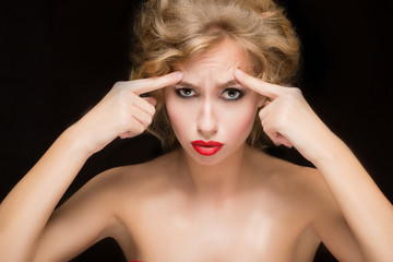 face of beautiful woman pointing at  her forehead