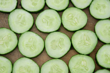 fresh cucumber slices on a wooden chop board