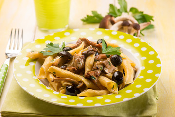 pasta with mushroom and black olives, selective focus