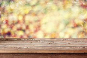Empty wooden table on an indistinct background with a side.