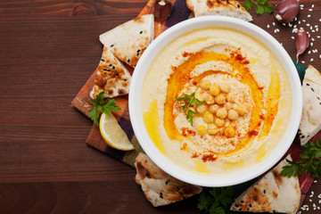 Hummus or houmous, appetizer made of mashed chickpeas with tahini, lemon, garlic, olive oil,...