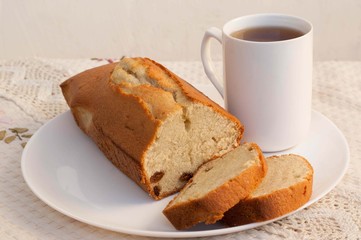Sweet cake with raisins and cup of tea 