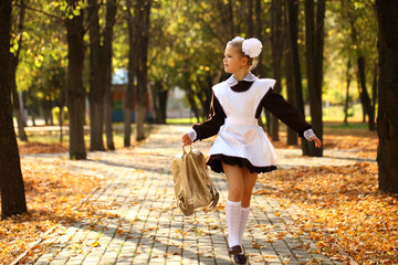 Happy little schoolgirl go home from school - obrazy, fototapety, plakaty