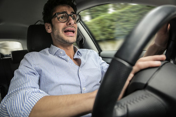 Worried man travelling by car
