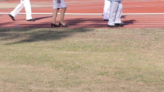 people walking in stadium, focus on foot
