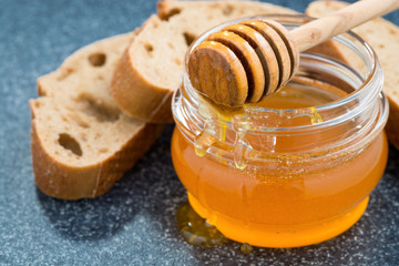 jar with honey and bread, close-up