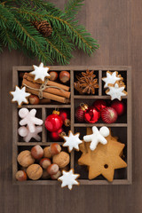 wooden box with Christmas symbols and spruce branches, top view