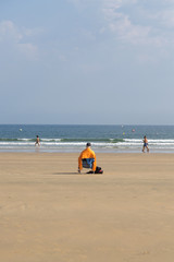 Obraz premium The sandy beach of the Atlantic Ocean. South of France. Basque Country. Hendaye. Blue sky with high clouds and yellow sand. horizon line in the middle. space for inscriptions