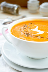 Vegetarian carrot-pumpkin cream soup with garlic and cumin
