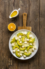 Salad with melon and avocado mini mozzarella orange-honey dressing     