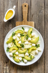 Salad with melon and avocado mini mozzarella orange-honey dressing     