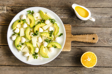 Salad with melon and avocado mini mozzarella orange-honey dressing     