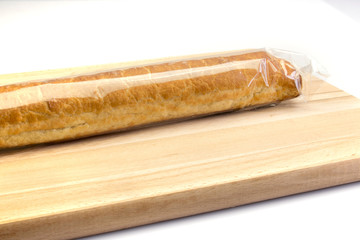 Wrapped almond bar on a wooden plate