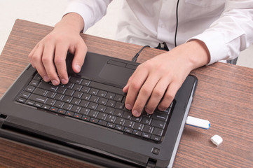 man's hands typing on keyboard computer laptop
