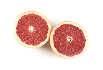 Two halfs of cutted red grapefruit isolated on white