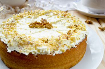 Homemade cake with butter cream and walnuts