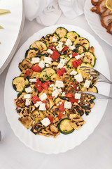 Grilled zucchini with cheese and tomato